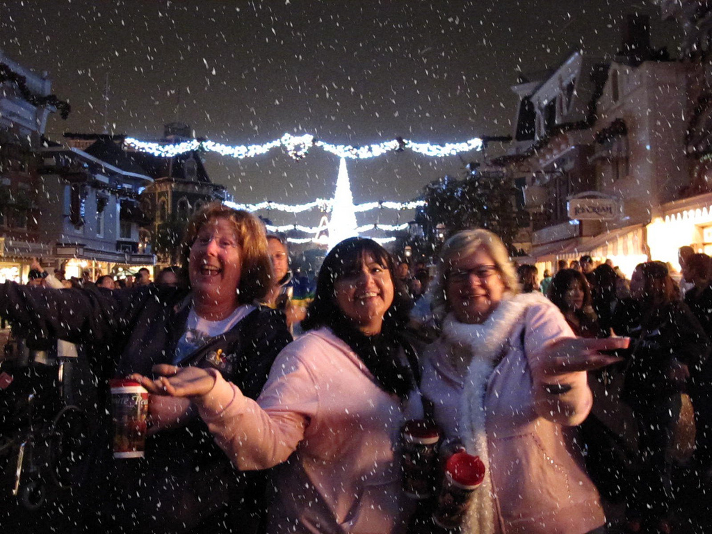 Guests laughing and playing in the snow at night