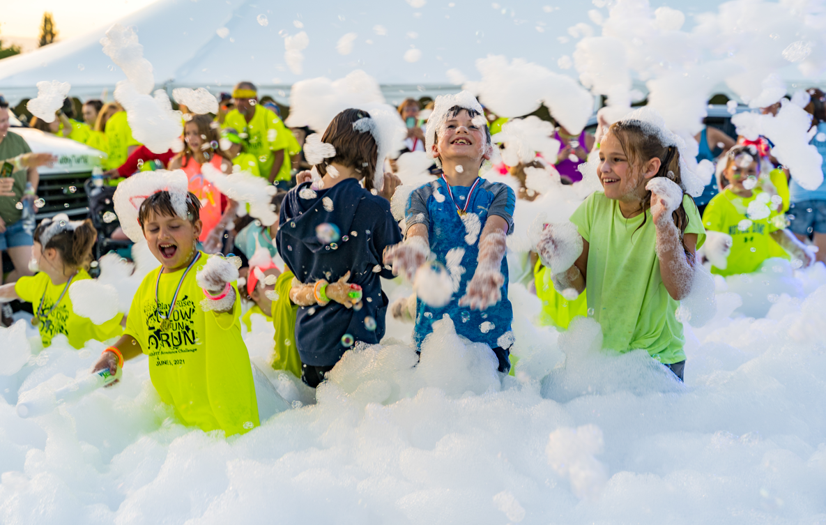 Kids running through foam at a party - Foam Zone Texas foam party rentals Friendswood, TX